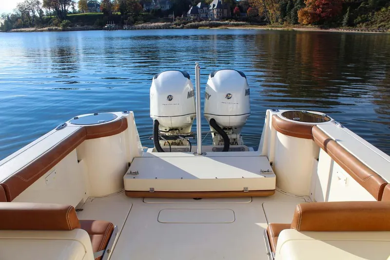 Scout 275 Dorado Yacht Photos Pics 2018 Scout 275 Dorado boat with twin outboard engines on a calm lake.