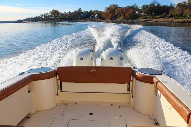 Scout 275 Dorado Yacht Photos Pics 2018 Scout 275 Dorado boat cruising on a calm lake with twin engines.