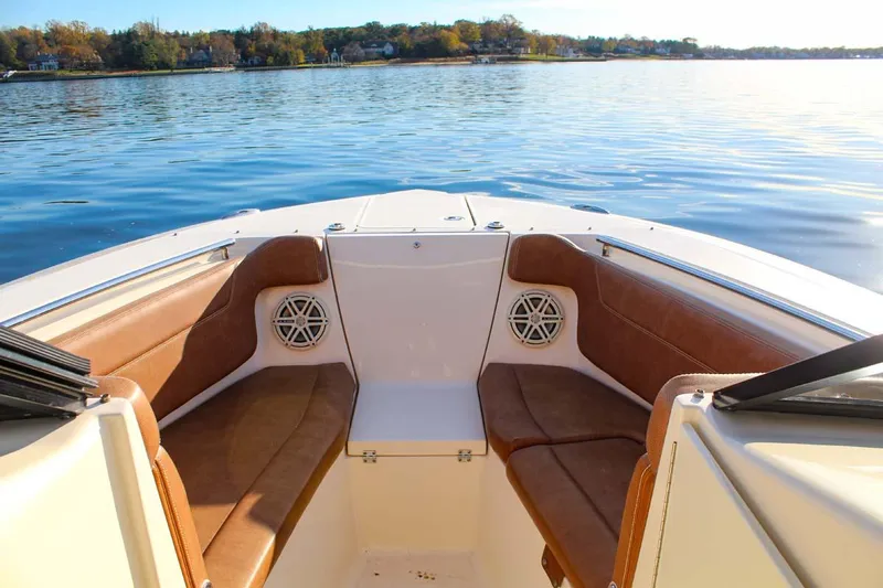 Scout 275 Dorado Yacht Photos Pics 2018 Scout 275 Dorado boat interior with brown seating on calm water.