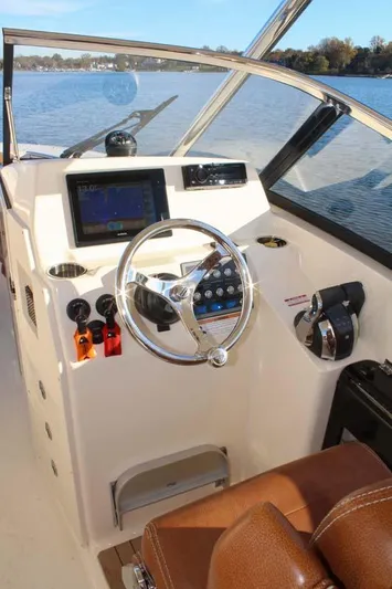 Scout 275 Dorado Yacht Photos Pics 2018 Scout 275 Dorado boat helm with steering wheel and navigation system.