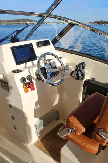 Scout 275 Dorado Yacht Photos Pics 2018 Scout 275 Dorado boat helm with modern controls and leather seat.
