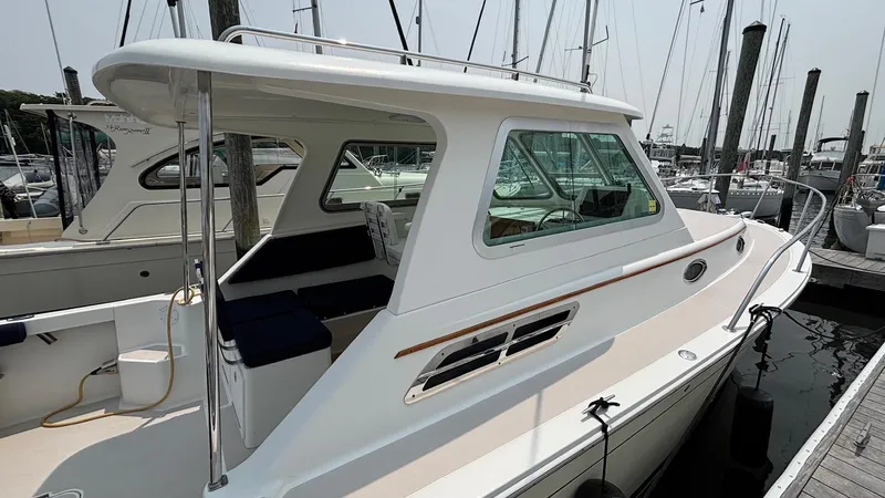 Uncle Ray Yacht Photos Pics 2004 Back Cove 29 boat docked at marina, featuring sleek design and spacious cabin.