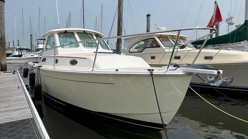 Uncle Ray Yacht Photos Pics 2004 Back Cove 29 boat docked at marina, featuring sleek design and white exterior.