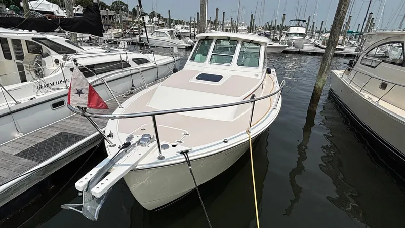 Uncle Ray Yacht Photos Pics 2004 Back Cove 29 boat docked in a marina, surrounded by other vessels.