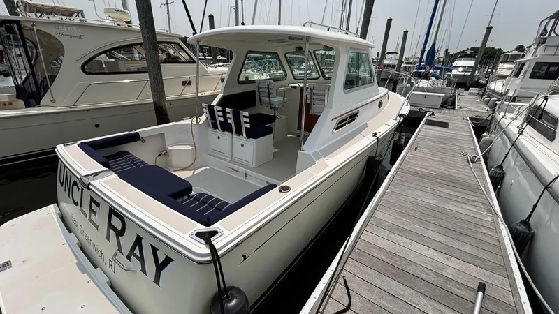 Uncle Ray Yacht Photos Pics 2004 Back Cove 29 boat docked at marina, featuring spacious deck and cabin.