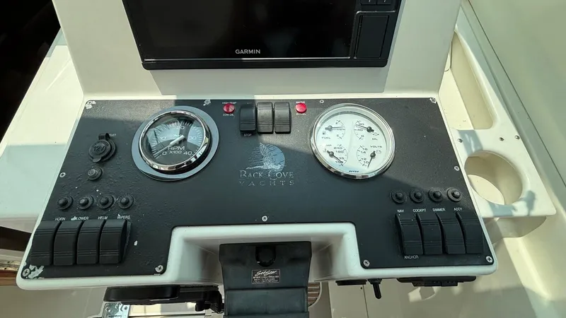 Uncle Ray Yacht Photos Pics Control panel of a 2004 Back Cove 29 boat with gauges and switches.