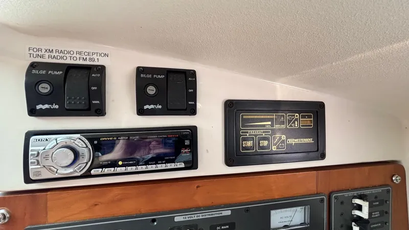 Uncle Ray Yacht Photos Pics Control panel of a 2004 Back Cove 29 boat with radio and bilge pump switches.