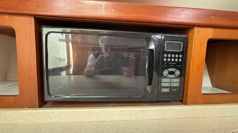 Uncle Ray Yacht Photos Pics Microwave in 2004 Back Cove 29 boat interior, wooden cabinetry.