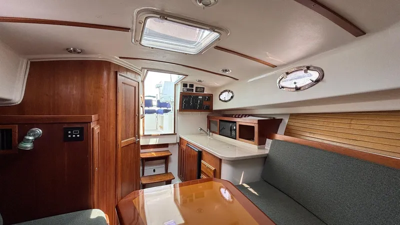 Uncle Ray Yacht Photos Pics Interior of 2004 Back Cove 29 boat, featuring wood finishes and seating area.