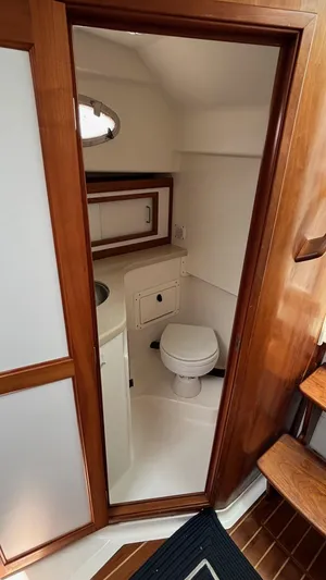 Uncle Ray Yacht Photos Pics 2004 Back Cove 29 boat interior with wooden trim and compact bathroom.