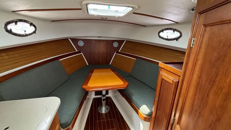 Uncle Ray Yacht Photos Pics 2004 Back Cove 29 interior with wood accents and seating area.