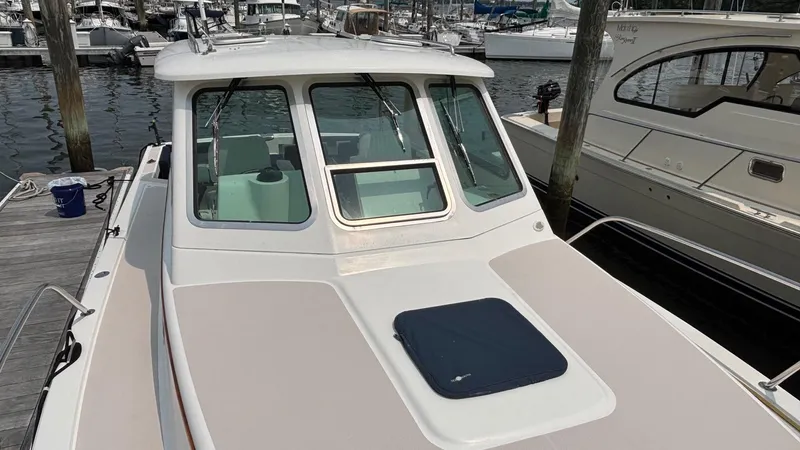 Uncle Ray Yacht Photos Pics 2004 Back Cove 29 boat docked at marina, featuring sleek cabin design and spacious deck.