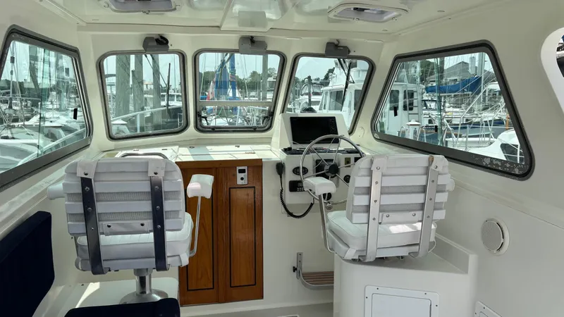 Uncle Ray Yacht Photos Pics Interior of a 2004 Back Cove 29 boat with helm and seating.