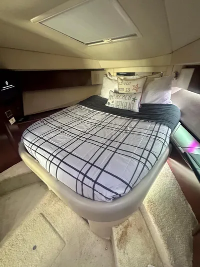  Yacht Photos Pics Interior cabin of 2007 Sea Ray 44 Sedan Bridge with cozy bed and plaid bedding.