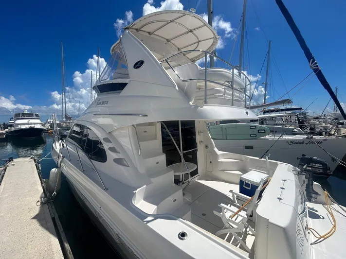  Yacht Photos Pics 2007 Sea Ray 44 Sedan Bridge yacht docked at marina under clear blue sky.