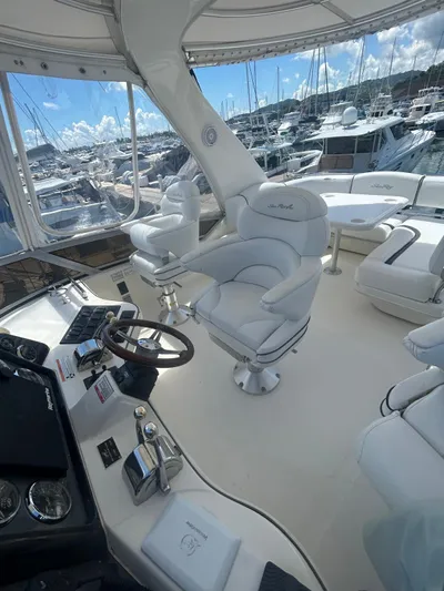  Yacht Photos Pics 2007 Sea Ray 44 Sedan Bridge yacht interior with white seating and helm, docked at marina.