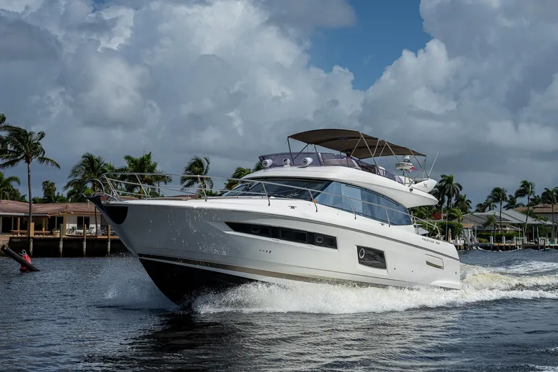 Lifesaver Yacht Photos Pics 2014 Prestige 550 yacht cruising on a sunny day with palm trees in the background.