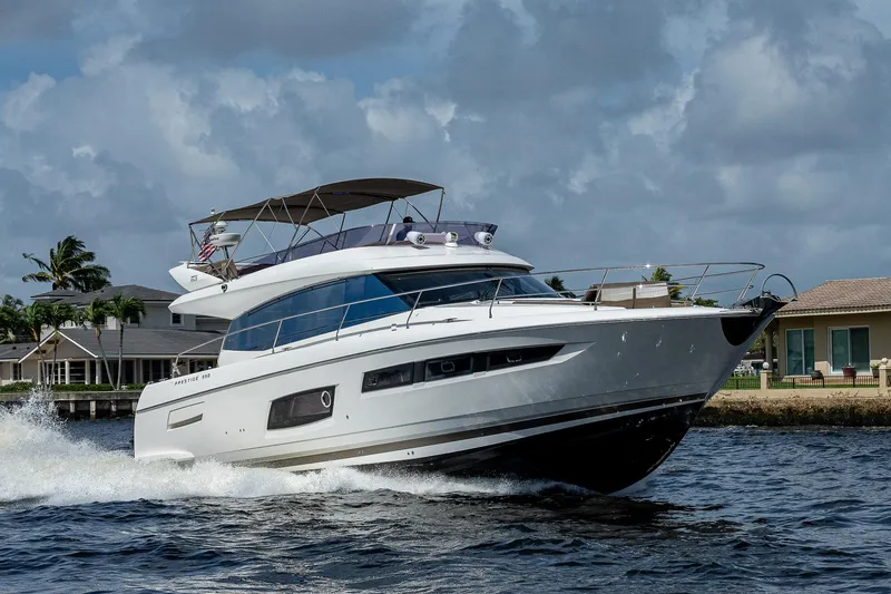 Lifesaver Yacht Photos Pics 2014 Prestige 550 yacht cruising on water under cloudy sky.