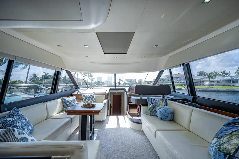 Lifesaver Yacht Photos Pics Luxurious interior of a 2014 Prestige 550 yacht with elegant seating and panoramic windows.