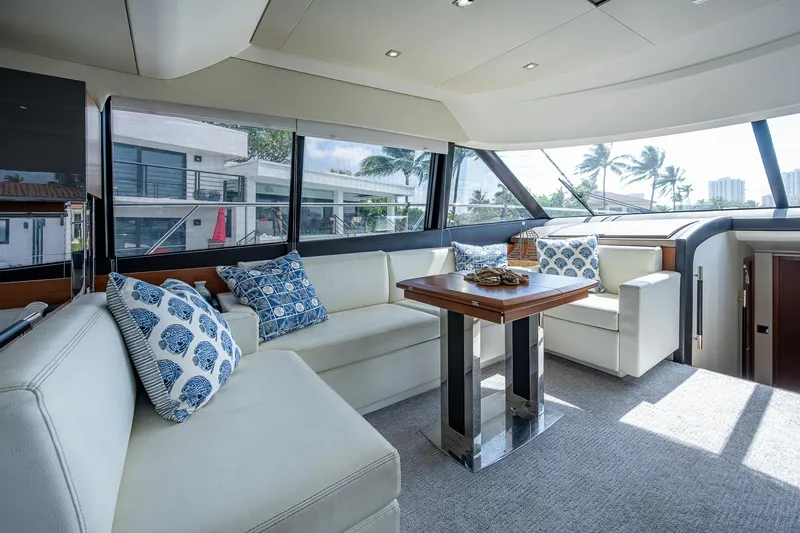 Lifesaver Yacht Photos Pics Luxurious interior of 2014 Prestige 550 yacht with elegant seating and decorative pillows.