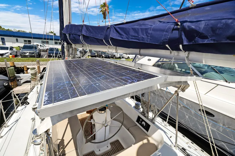 Southern Cross Yacht Photos Pics Sailboat with solar panel, Hylas 46 model, 2004, docked at marina under blue sky.