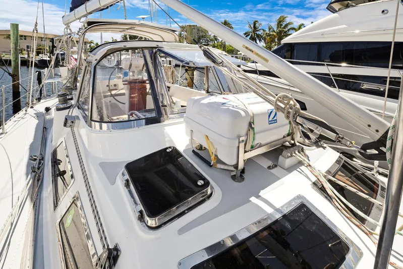 Southern Cross Yacht Photos Pics 2004 Hylas 46 sailboat deck with lifeboat, docked in sunny marina.