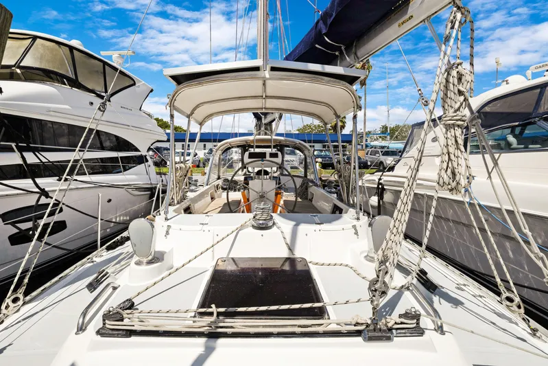 Southern Cross Yacht Photos Pics 2004 Hylas 46 sailboat docked between yachts under a clear blue sky.