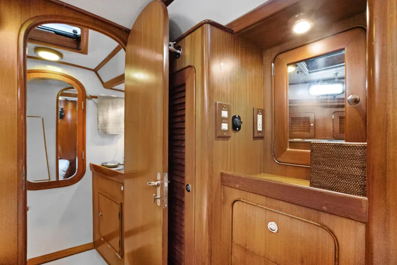 Southern Cross Yacht Photos Pics Interior of 2004 Hylas 46 yacht featuring wooden cabinetry and modern lighting.