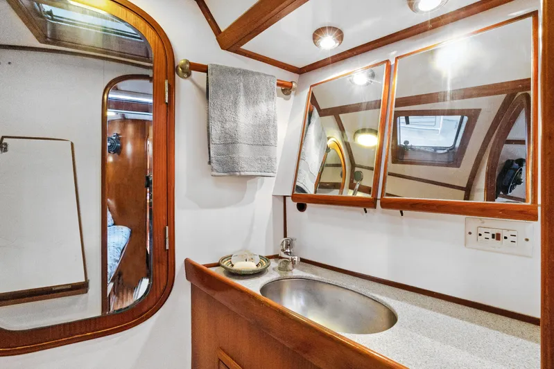 Southern Cross Yacht Photos Pics Luxurious bathroom interior of 2004 Hylas 46 yacht with wooden accents and modern fixtures.