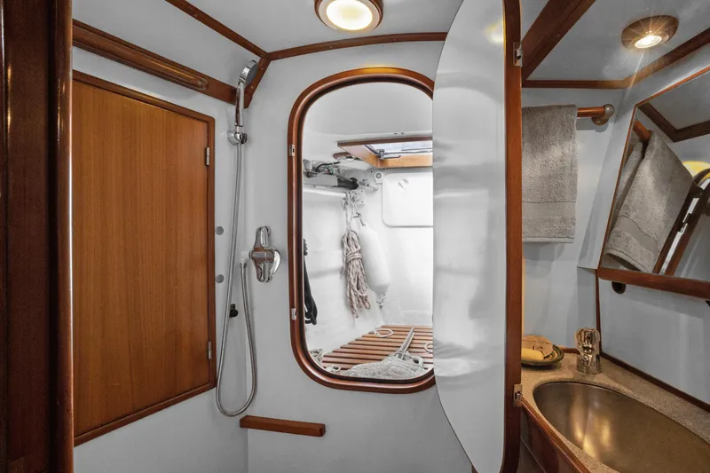 Southern Cross Yacht Photos Pics Luxurious bathroom interior of a 2004 Hylas 46 yacht, featuring wood accents and modern fixtures.