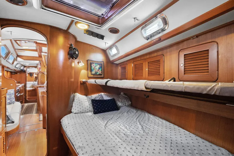 Southern Cross Yacht Photos Pics Interior of 2004 Hylas 46 yacht with cozy wooden cabin and comfortable bedding.