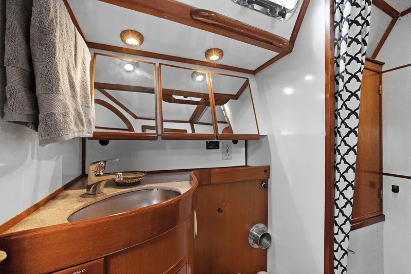 Southern Cross Yacht Photos Pics Luxurious 2004 Hylas 46 yacht bathroom with wood accents and modern fixtures.