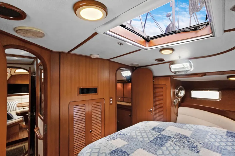 Southern Cross Yacht Photos Pics Luxurious interior of a 2004 Hylas 46 yacht with wood paneling and skylight.