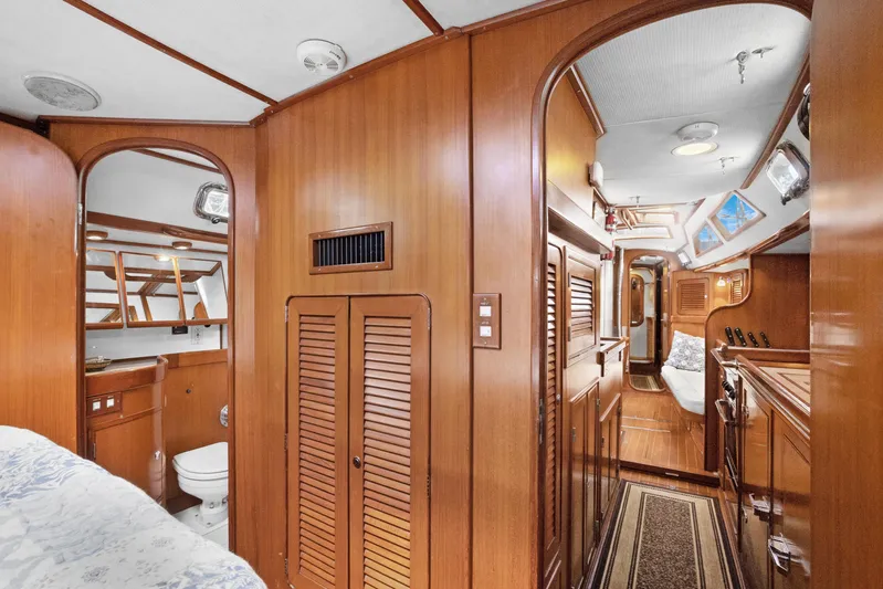 Southern Cross Yacht Photos Pics Interior of 2004 Hylas 46 yacht featuring wood paneling and cozy living space.