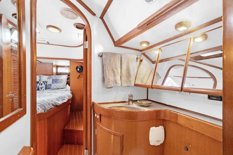 Southern Cross Yacht Photos Pics Luxurious 2004 Hylas 46 yacht interior with wooden cabinetry and cozy bedroom.