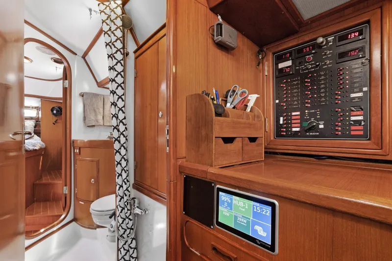 Southern Cross Yacht Photos Pics Interior of 2004 Hylas 46 yacht with control panel and bathroom.