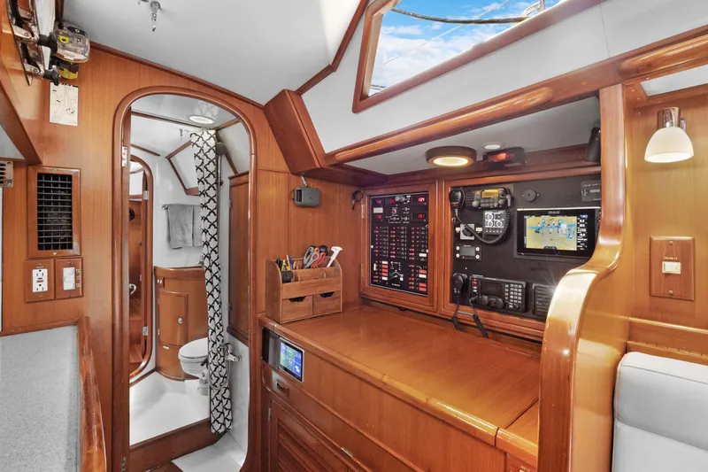 Southern Cross Yacht Photos Pics Interior of 2004 Hylas 46 yacht with navigation station and bathroom.