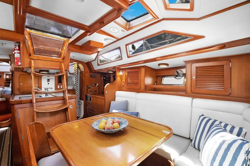 Southern Cross Yacht Photos Pics Luxurious interior of a 2004 Hylas 46 yacht with wooden finishes and comfortable seating.
