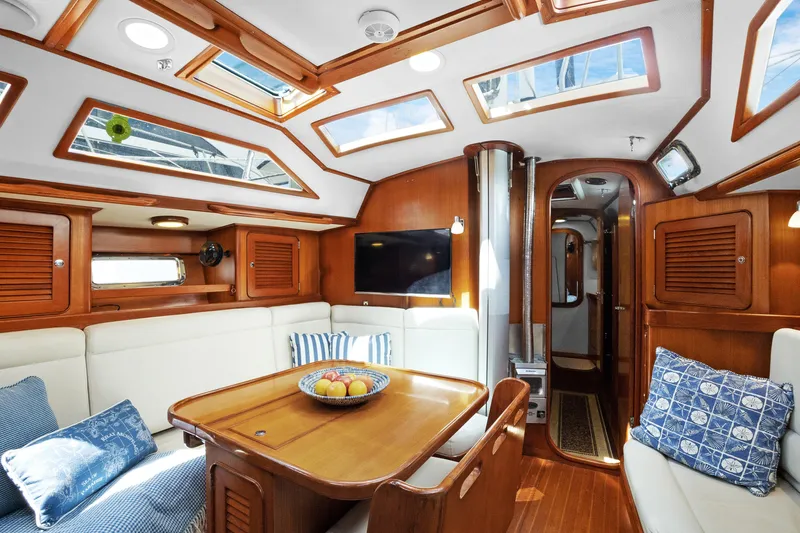 Southern Cross Yacht Photos Pics Luxurious interior of a 2004 Hylas 46 yacht with skylights and elegant wood finish.