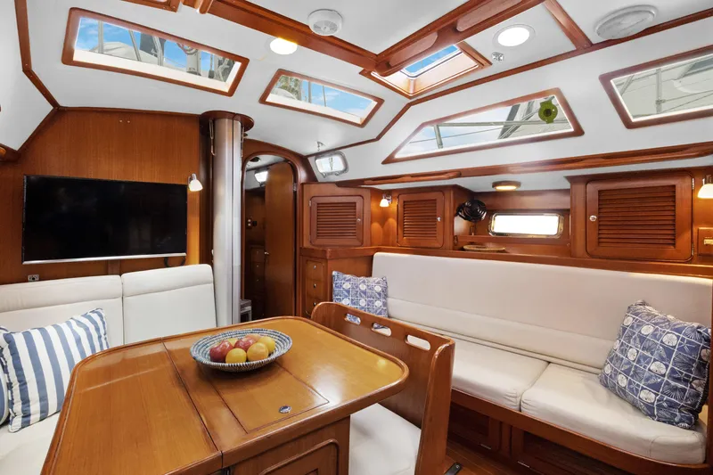 Southern Cross Yacht Photos Pics Luxurious 2004 Hylas 46 yacht interior with elegant wood finish and comfortable seating.