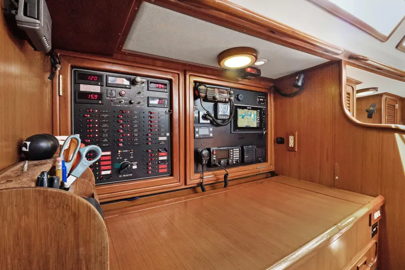 Southern Cross Yacht Photos Pics Navigation station on a 2004 Hylas 46 yacht with control panels and equipment.