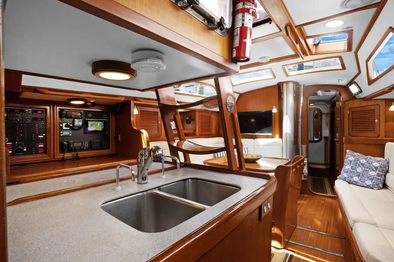 Southern Cross Yacht Photos Pics Interior of 2004 Hylas 46 yacht with modern kitchen and cozy seating area.