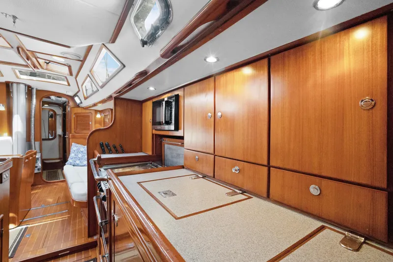 Southern Cross Yacht Photos Pics Luxurious 2004 Hylas 46 yacht interior with elegant wood cabinetry and modern amenities.