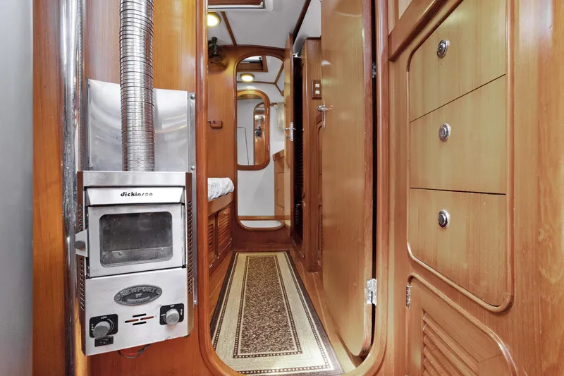 Southern Cross Yacht Photos Pics Interior of 2004 Hylas 46 yacht with wood paneling and Dickinson heater.