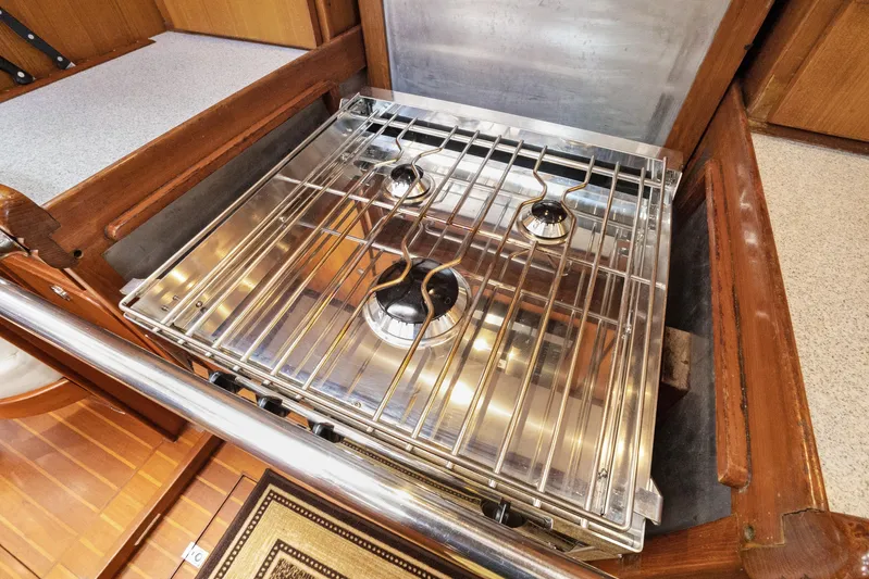 Southern Cross Yacht Photos Pics Stainless steel stove in 2004 Hylas 46 yacht kitchen, featuring three burners.