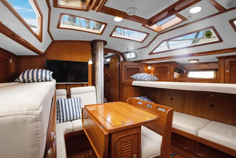 Southern Cross Yacht Photos Pics Luxurious interior of 2004 Hylas 46 yacht with skylights and wooden furnishings.