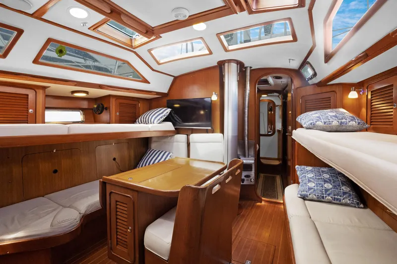 Southern Cross Yacht Photos Pics Luxurious interior of a 2004 Hylas 46 yacht with wooden finishes and skylights.