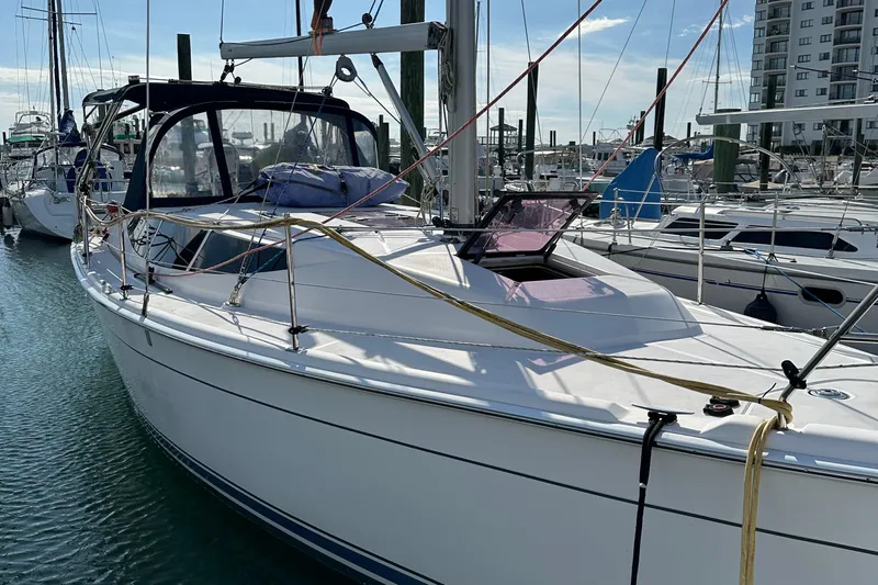 To The Gills Yacht Photos Pics 2014 Hunter 33 sailboat docked in marina, clear sky, calm water.