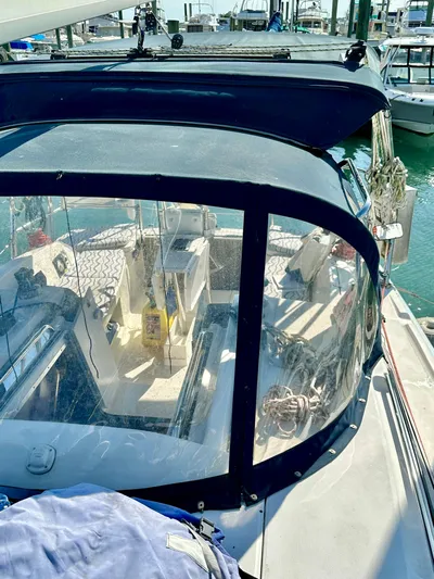 To The Gills Yacht Photos Pics 2014 Hunter 33 sailboat cockpit with clear enclosure, docked at marina.