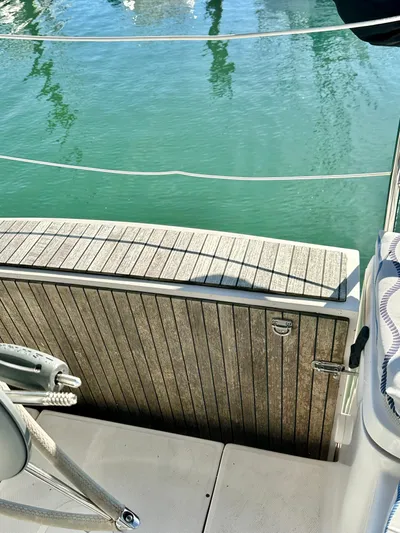 To The Gills Yacht Photos Pics Hunter 33 sailboat deck, 2014 model, with wooden finish and view of calm water.
